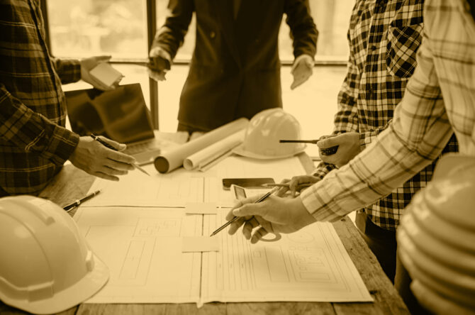 Engineer teams meeting working together wear worker helmets hardhat on construction site in city.Asian industry professional team