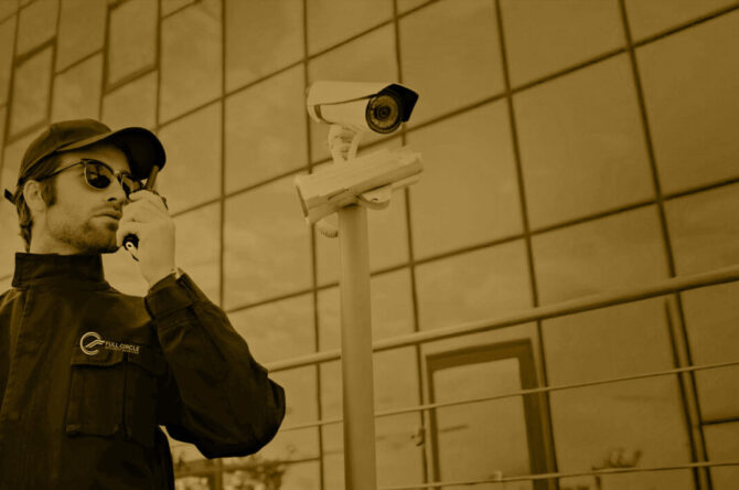 security man in sunglasses and black uniform talking on radio se